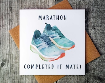 May include: A white card with the text "Marathon Completed It Mate!" and a watercolour illustration of two blue running shoes.