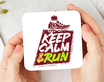 May include: White coaster with a red, white, and yellow graphic that says "Keep Calm & Run". A red running shoe with a yellow crown is on top of the text.