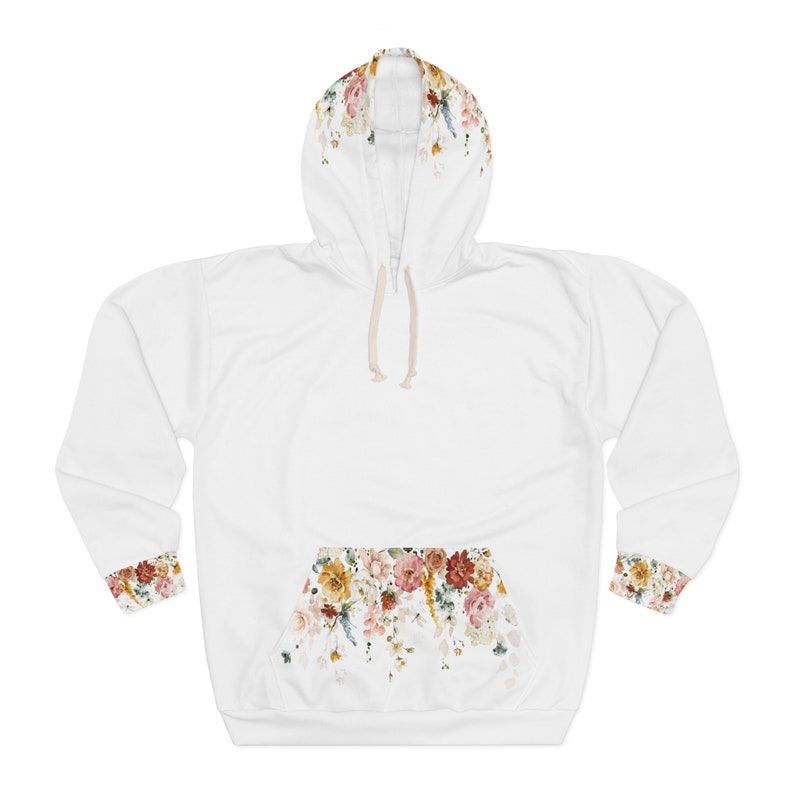 Op de afbeelding: Witte hoodie met een bloemenprint op de capuchon, zak en manchetten. De bloemenprint heeft een verscheidenheid aan kleuren, waaronder rood, roze, geel en groen.