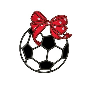 May include: A black and white soccer ball with a red bow with white polka dots. The bow is tied around the top of the ball.