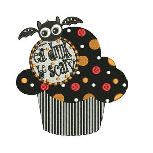 May include: A black and white cupcake with orange and red polka dots. A bat with googly eyes sits on top of the cupcake. The cupcake has a white and black striped base and a circle with the text "Eat Drink Be Scary" on top.
