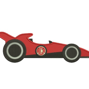 Può includere: Macchina da corsa rossa con ruote nere e un monogramma in bianco e nero in un cerchio sul lato. Il monogramma è "ACR".