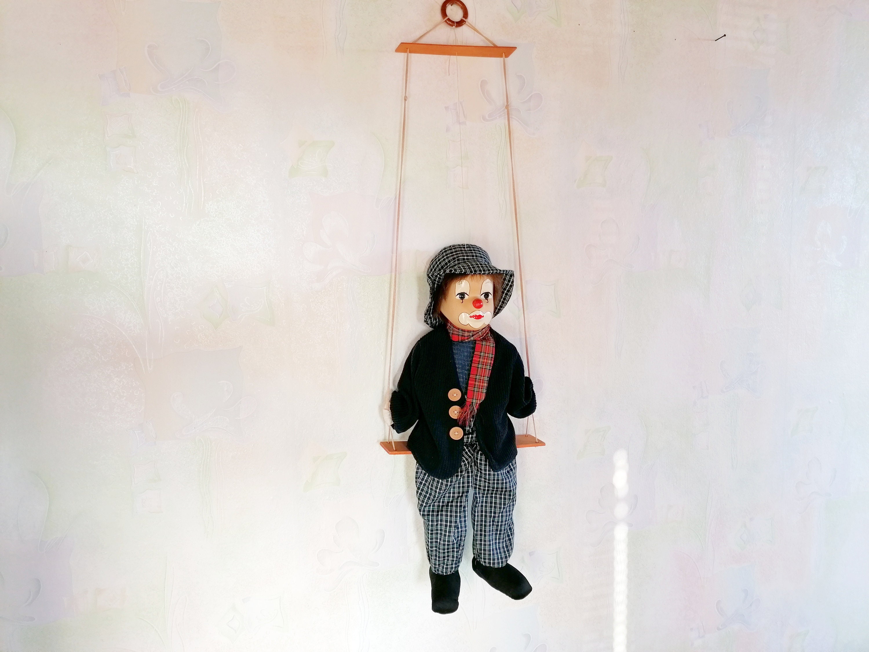 porcelain clown on swing