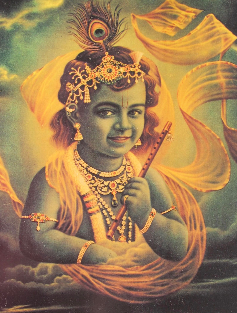 May include: A painting of a young boy with dark hair and blue skin. He is wearing a gold crown and a yellow and gold garment. He is holding a flute in his right hand and has a peacock feather in his hair.