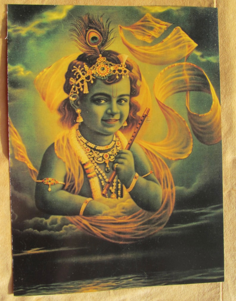 May include: A painting of a young boy with blue skin, wearing a yellow and gold robe and a jeweled crown. He is holding a flute and has a peacock feather in his hair.