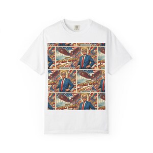 May include: White t-shirt featuring a repeating pattern. The pattern includes an illustration of a man in a blue suit and red tie, an eagle, and the text "PEACE MAKER". The background has red, white, and blue elements.