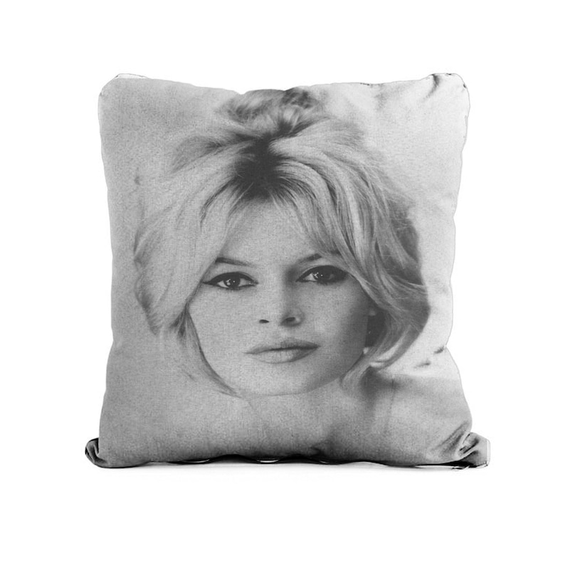 May include: Black and white photograph of a woman with blonde hair. The image is printed on a square pillow.