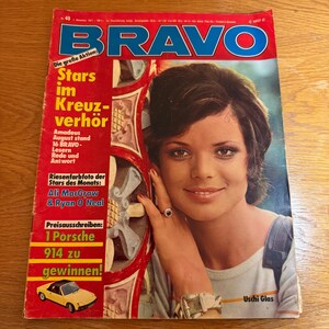Pode incluir: Uma capa de revista vintage com uma mulher. A revista é intitulada "BRAVO" em azul. O texto inclui "Stars im Kreuzverhör" e "1 Porsche 914 zu gewinnen!". A capa é vermelha com texto amarelo.
