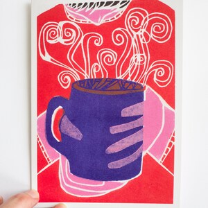 May include: A purple coffee mug with a pink and red background. The mug has steam coming out of it, which is depicted as white swirls.