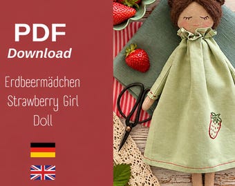 May include: A PDF download pattern for a fabric doll with brown yarn hair, closed eyes, and a light green dress featuring a small embroidered strawberry. The text on the left reads PDF Download Erdbeermädchen Strawberry Girl Doll.