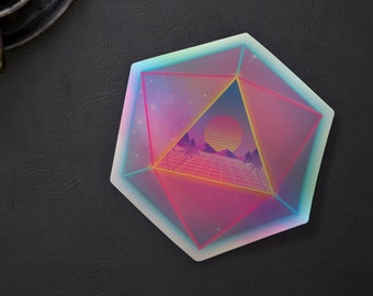 Puede incluir: Un posavasos geométrico rosa, azul y amarillo con una escena retro de puesta de sol en su interior. El posavasos tiene forma de pentágono.