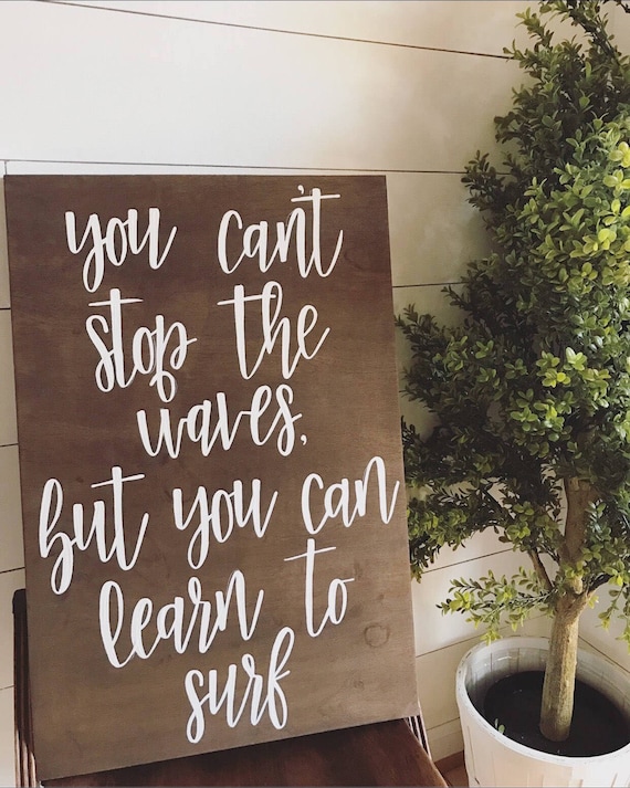 You can't stop the waves but you can learn tk surf - wood sign