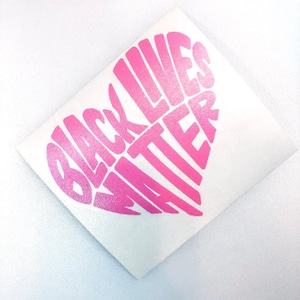 May include: Pink vinyl decal in the shape of a heart with the words "Black Lives Matter" written inside.