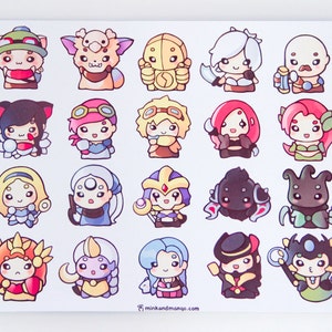 May include: A sheet of 16 colourful cartoon stickers featuring characters from the popular video game League of Legends. The stickers are printed on a white background and feature a variety of characters, including a bear, a spider, a woman with a crown, and a woman with a fish tail.