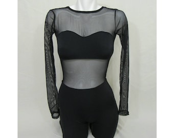 May include: Black bodysuit with long sheer sleeves and a sweetheart neckline. The bodice is a solid black material with a sheer mesh overlay. The shorts portion is also solid black. The garment is displayed on a white mannequin.