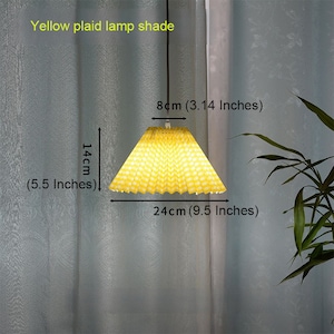 May include: Yellow plaid lamp shade with a pleated design. The shade measures 9.5 inches in diameter and 5.5 inches in height.