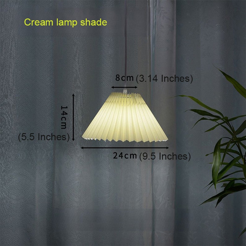 May include: Cream colored pleated lampshade with a diameter of 9.5 inches and a height of 5.5 inches.