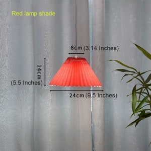 May include: Red lamp shade with a pleated design. The shade measures 9.5 inches in diameter and 5.5 inches in height.