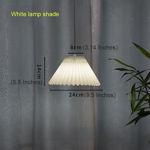 May include: White pleated lampshade with a diameter of 9.5 inches and a height of 5.5 inches. The lampshade is 3.14 inches tall.