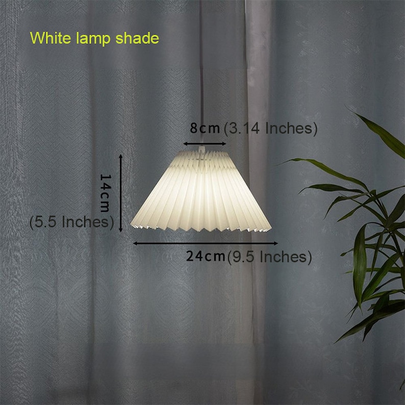 May include: White pleated lampshade with a diameter of 9.5 inches and a height of 5.5 inches. The lampshade is 3.14 inches tall.
