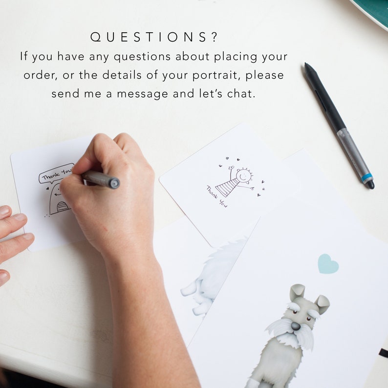 May include: A hand holding a pen and writing on a white card with the text "Thank You" and a simple drawing of a person. The card is on a white surface.