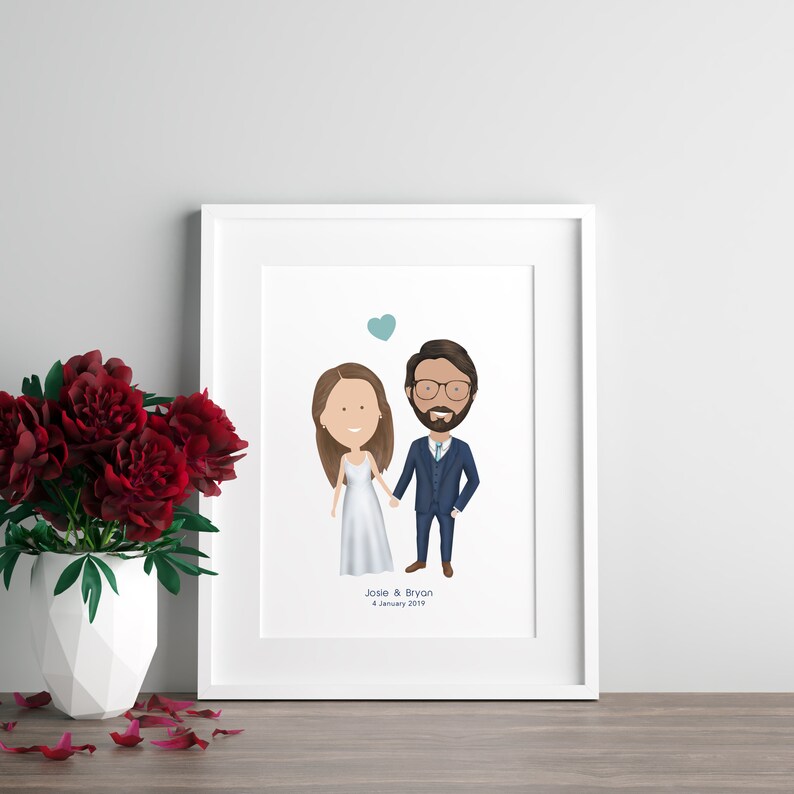 May include: A white frame with a cartoon illustration of a bride and groom holding hands. The text "Josie & Bryan 4 January 2019" is below the illustration.