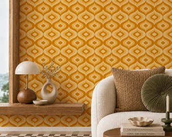 May include: A retro-style interior scene featuring a mustard yellow wallpaper with a repeating teardrop pattern. A white sofa with brown and olive green pillows is in front of the wallpaper. A wooden shelf holds a lamp, vase, and bowl.