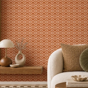 May include: Wallpaper featuring a repeating geometric pattern of interconnected orange and cream-colored ogee shapes. The design creates a continuous, symmetrical grid across the surface, characterized by warm, earthy tones and a structured, rhythmic layout.