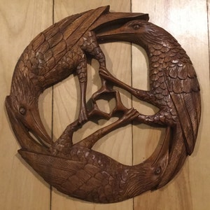 Triple raven round wood carving