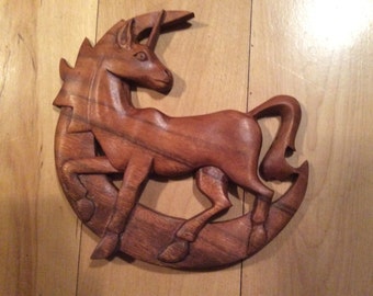 Carved unicorn on moon wood carving