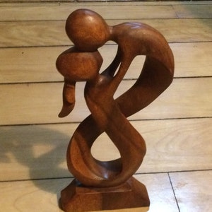 Abstract wood carved kissing couple