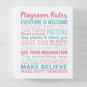 May include: A white sign with pink and blue text that reads "Playroom Rules" and lists rules for children, such as "Share your toys", "Take turns", "Pretend", "Read a book", "Say please & thank you", "Have fun", "Be kind", "Giggle", "Clean up your things", "Use your imagination", "Try something new", "Be creative", "Dream big", "Make music", "Make believe", and "Make happy memories".