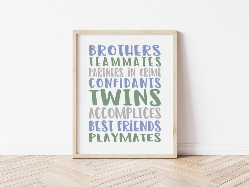 May include: A framed print with the words "Brothers, Teammates, Partners in Crime, Confidants, Twins, Accomplices, Best Friends, Playmates" in blue and green lettering on a white background.