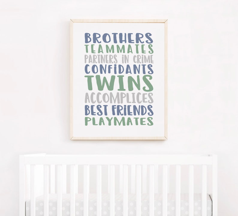 May include: A framed print with the words "Brothers, Teammates, Partners in Crime, Confidants, Twins, Accomplices, Best Friends, Playmates" in blue and green text on a white background.