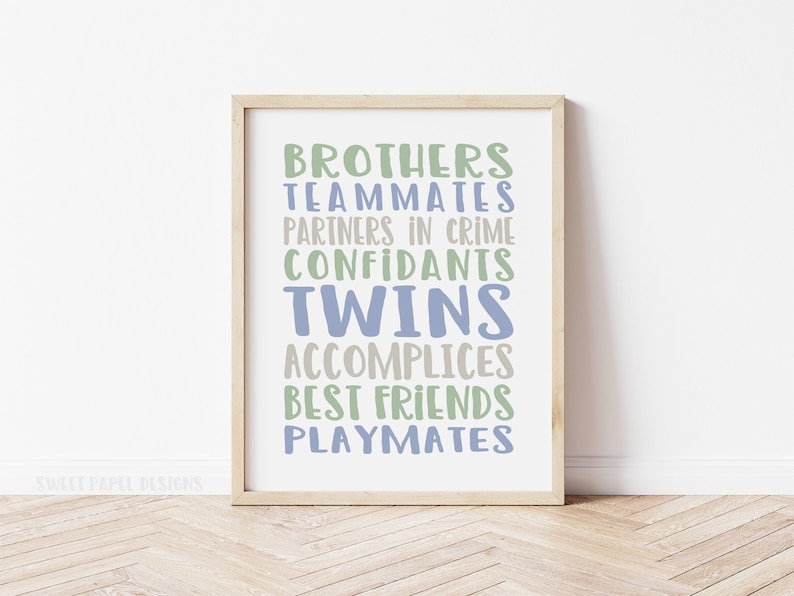 May include: A framed print with the text "Brothers, Teammates, Partners in Crime, Confidants, Twins, Accomplices, Best Friends, Playmates" in blue and green lettering on a white background.