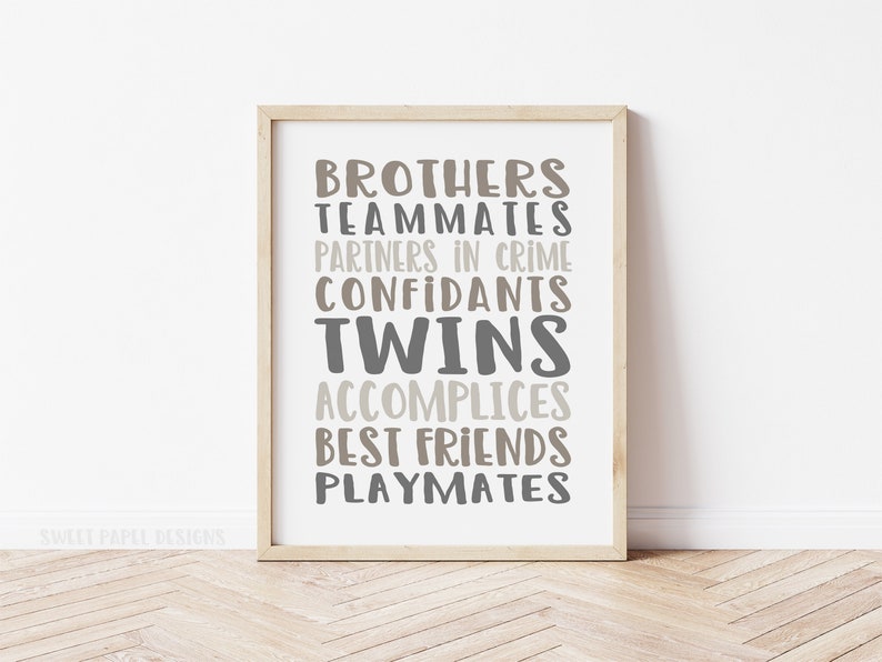 May include: A framed print with the words "Brothers, Teammates, Partners in Crime, Confidants, Twins, Accomplices, Best Friends, Playmates" in a gray and brown color scheme. The text is arranged in a vertical column with the word "Twins" in a larger font size.