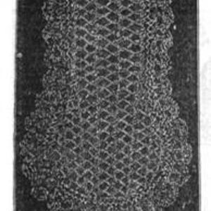 May include: A black and white image of a crocheted item, possibly a garment or decorative piece. The item features a diamond-patterned central section with a scalloped edge. The texture suggests a handmade craft, with visible stitch details.