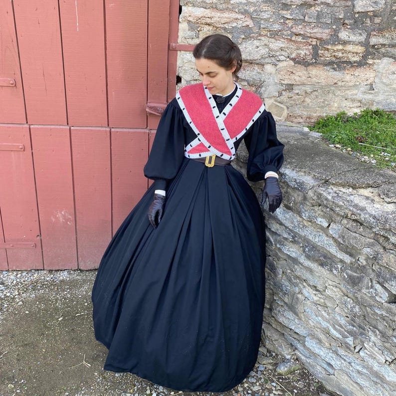 May include: A white ceramic mug with a black handle and the text "But First, Coffee" in a black, bold font. The mug is on a white surface.