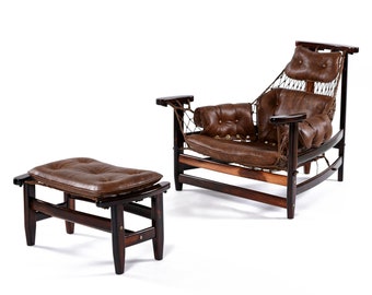 May include: A vintage-style armchair and ottoman set. The chair features a dark wooden frame, brown leather cushions, and a woven back. The ottoman has a matching leather cushion. The set is designed for comfort and relaxation.