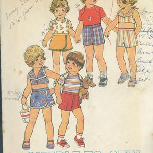 May include: Vintage Simplicity sewing pattern 7503 for toddler clothing. The pattern features illustrations of children in various outfits, including a wrap skirt, shorts, and a striped top. The pattern is sized for a 56 cm chest.