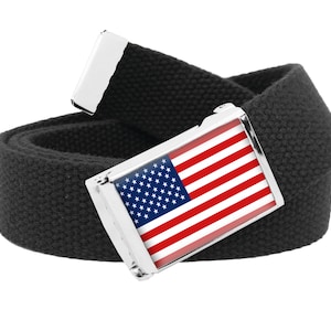 May include: Black canvas belt with a silver buckle featuring the American flag. The buckle has a rectangular shape with the flag's stars and stripes design. The belt is rolled up, showing its texture.