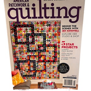 May include: The cover of "American Patchwork & Quilting" magazine features a colorful quilt with geometric patterns. The magazine also includes articles on quilting techniques and projects, with the text "5 Star Projects" and "How to Wash & Care for Quilts."