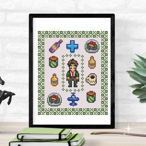 May include: A pixel art cross-stitch pattern featuring a character in a green jacket and brown pants, surrounded by various pixelated items, including a bottle, a jar, a cup of coffee, a plane, and a bowl of food. The pattern is framed in a black frame.