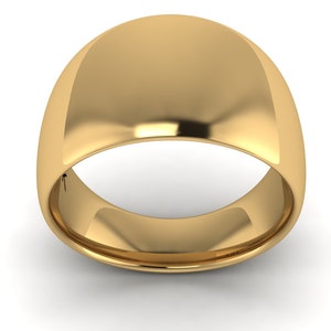May include: A gold wedding band with a rounded, domed top.