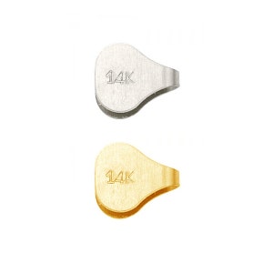 May include: Two 14k gold bead caps, one silver and one gold. The bead caps are oval shaped with a small loop on the side.