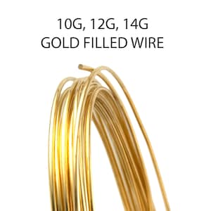 May include: A coil of gold-filled wire, with the text "10G, 12G, 14G GOLD FILLED WIRE" in black. The wire is a bright, shiny gold color, and is tightly coiled. The background is white.