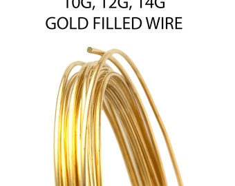 May include: A coil of gold filled wire with a bright metallic finish. The text 10G, 12G, 14G GOLD FILLED WIRE is printed above the wire. The wire is arranged in a circular loop, showing a smooth, reflective surface and a consistent round cross-section.
