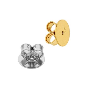 May include: Two earring backs, one gold and one silver. The gold earring back has a 585 stamp on the back. Both earring backs have a butterfly clasp.