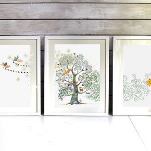 May include: Three framed illustrations in white frames. The left illustration shows two angels flying with a string of colourful flags. The middle illustration shows a tree with a fox, a deer, birds, and other animals. The right illustration shows a sun with green swirls around it.