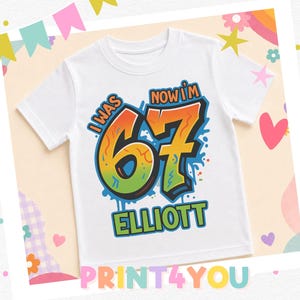 A white t-shirt with a colorful graphic design that says "I WAS NOW I'M 67 ELLIOTT" printed on it.